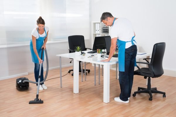 Two Professional Janitors Are Cleaning The Modern Office